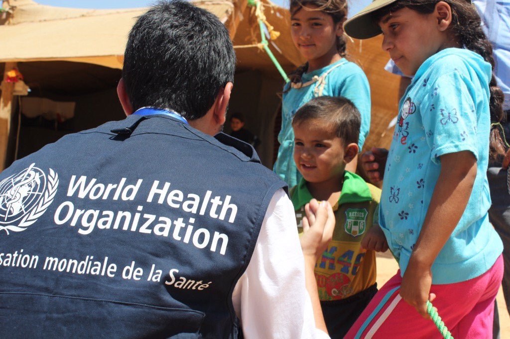 A health worker supporting children in a humanitarian setting
